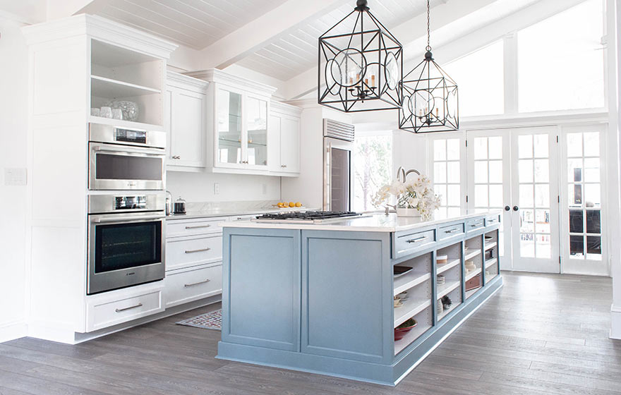 Calming blue painted cabinetry create a peaceful retreat while floor to ceiling cabinetry provides storage to hide everything away.