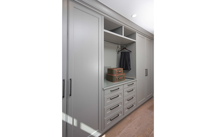 Floor to ceiling cabinetry in grey, provides a clean look, the simplicity of the room helps keep the focus on getting ready and out the door.