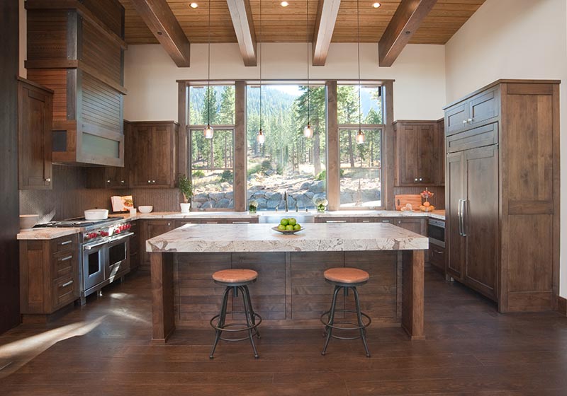 The beauty of stained Alder fits perfectly in this kitchen, perched in the mountains' natural surroundings.