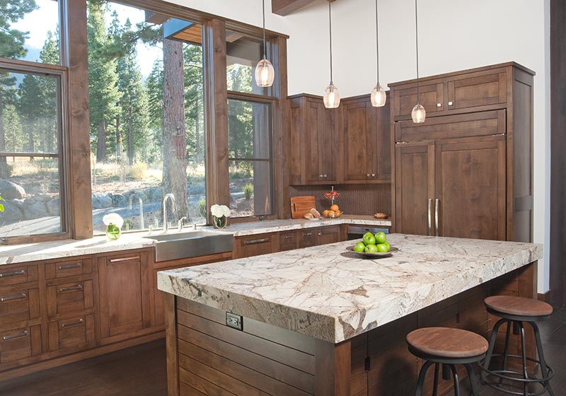 The beauty of stained Alder fits perfectly in this kitchen, perched in the mountains' natural surroundings.