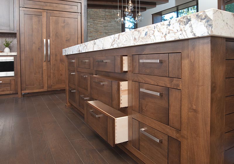 The beauty of stained Alder fits perfectly in this kitchen, perched in the mountains' natural surroundings.