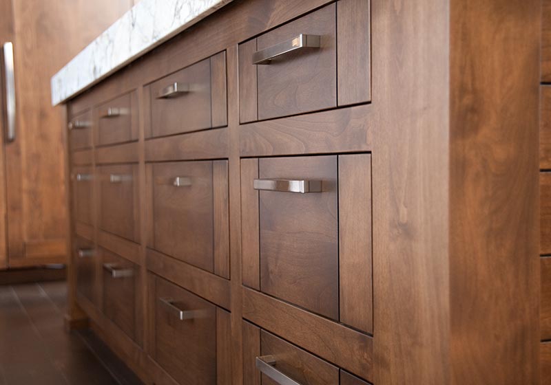 The beauty of stained Alder fits perfectly in this kitchen, perched in the mountains' natural surroundings.