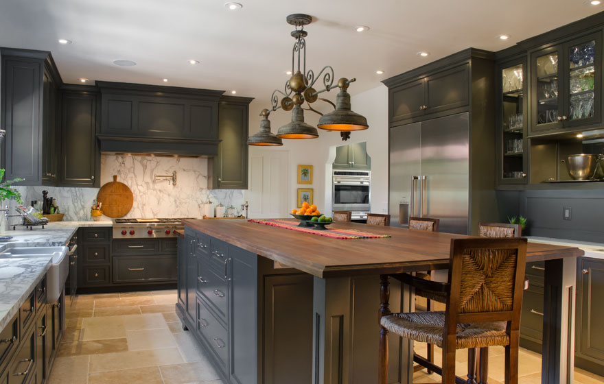 Dark paint creates a dramatic look in this kitchen with all the right custom details.