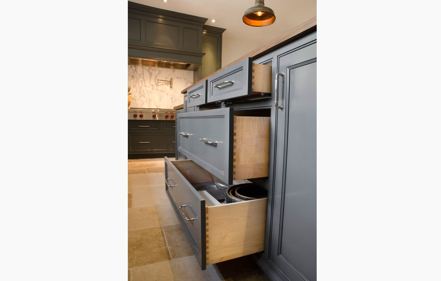 Dark paint creates a dramatic look in this kitchen with all the right custom details.