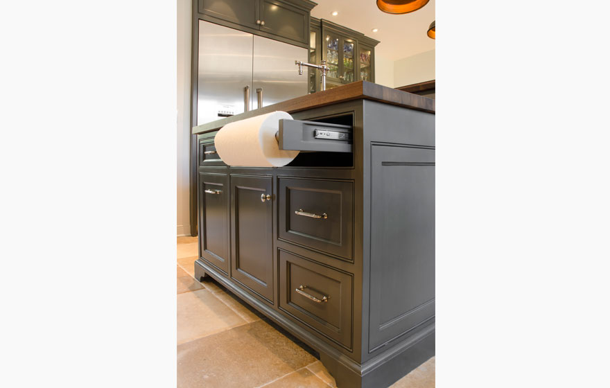 Dark paint creates a dramatic look in this kitchen with all the right custom details.