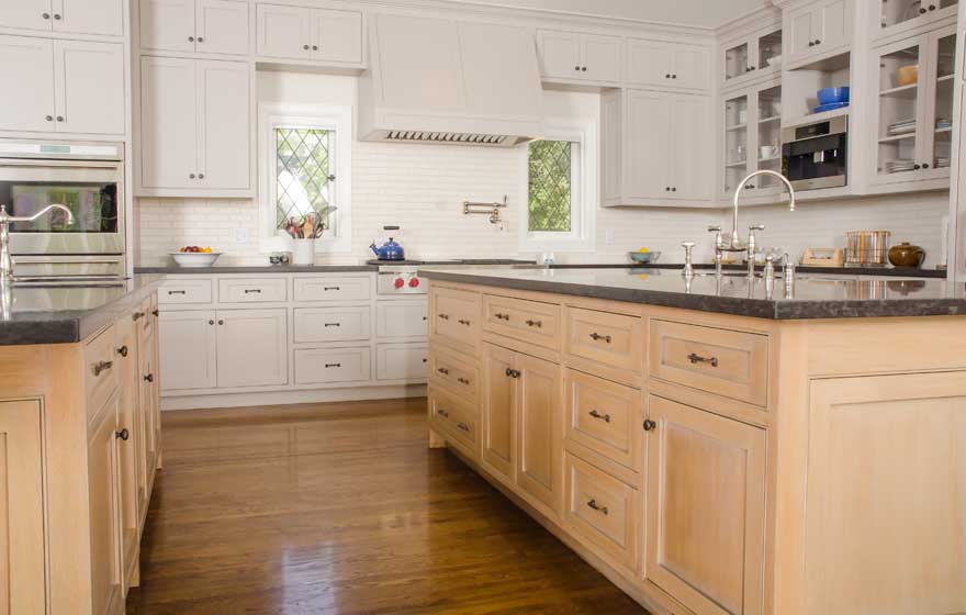 Rift Sawn White Oak pairs with painted cabinetry for a chic look in this large kitchen featuring dual islands.