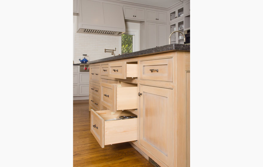 Rift Sawn White Oak pairs with painted cabinetry for a chic look in this large kitchen featuring dual islands.