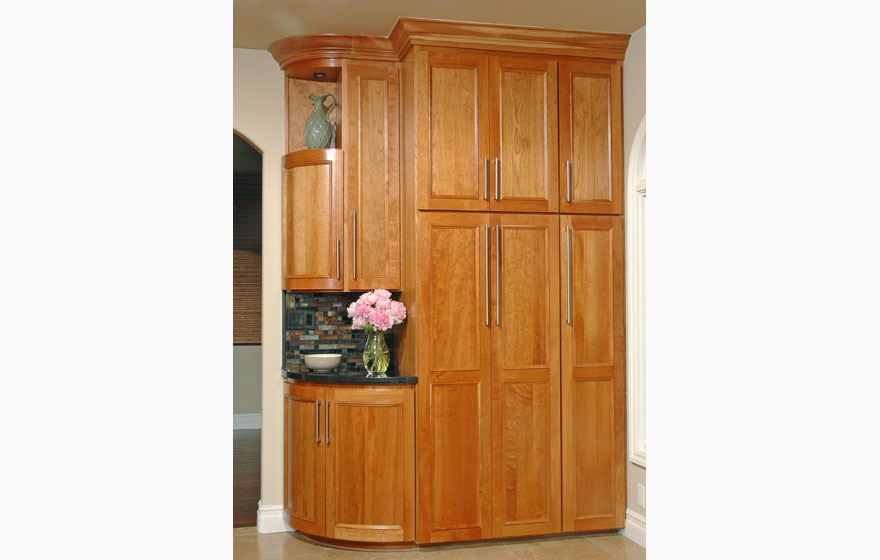 Let the beauty of cherry shine through by using a clear or light stain and using dark tile and granite to make the cabinetry the focal point.