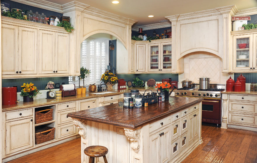 A large island and the tops of upper cabinets become a perfect home for containers and treasures to add a stylized look.