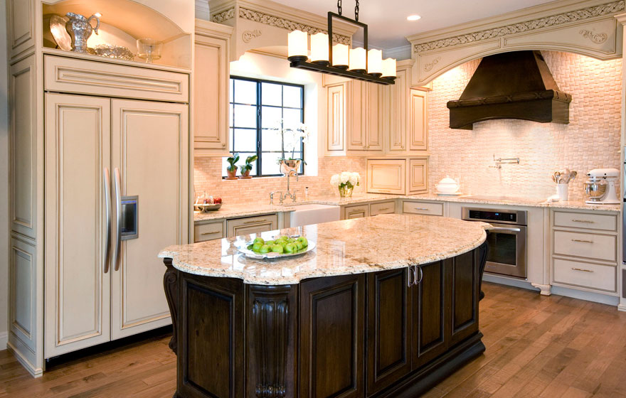 Dramatic and elegant, this two-tone kitchen design with light colored wall cabinetry keeps the space open and airy while the dark, luxurious island creates a rich focal point.