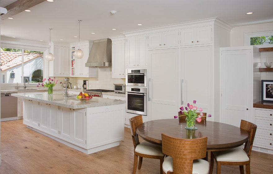 Custom designed wood cabinet doors were used in this stunning kitchen and dining space to bring a truly high end look.