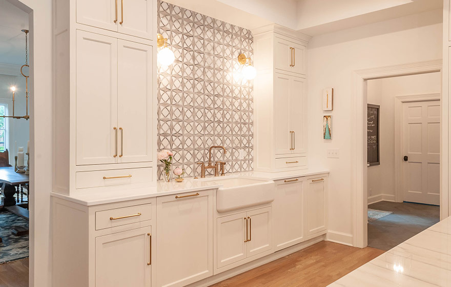 Beautiful blue paint add just the right amount of color to this stunning white kitchen